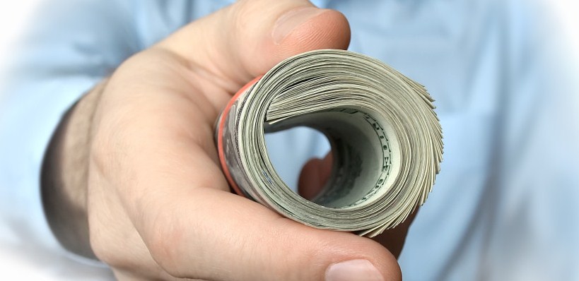 handing dollar bills